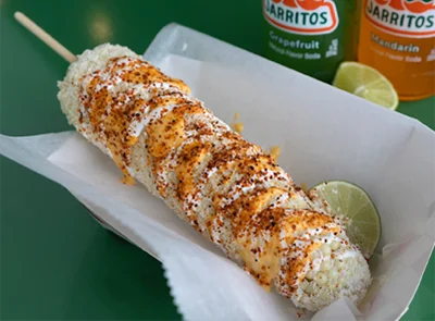 traditional elote loaded with cheese and sour cream